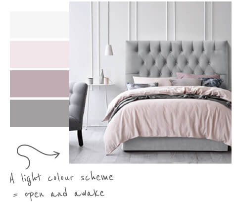 bedroom with upholstered headboard and bed with comfy bedding with light greys and light pinks